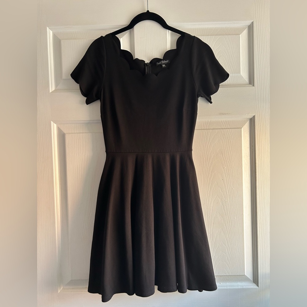 Black short sleeve knit dress with scalloped neckline and sleeves